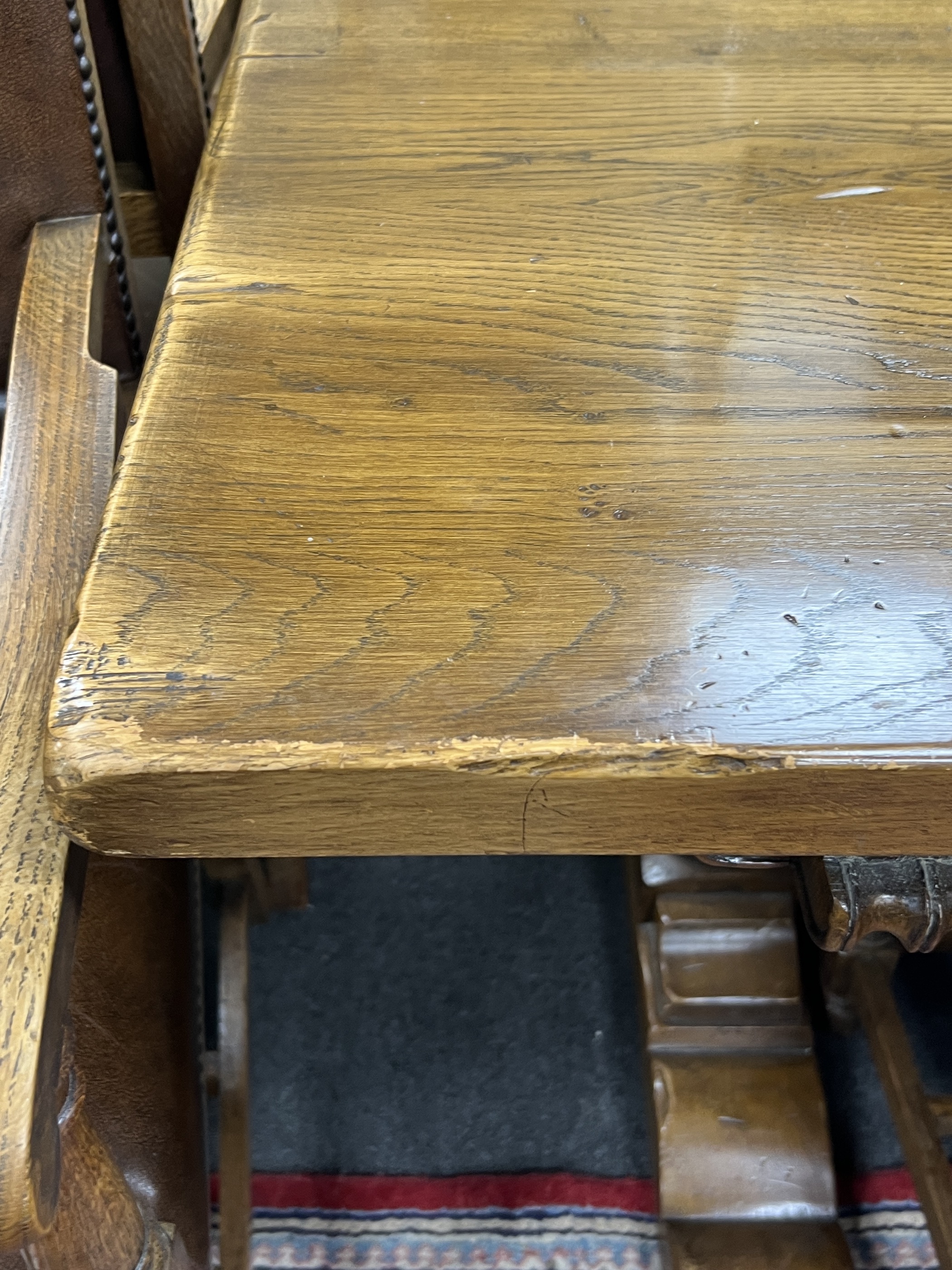 An 18th century style oak refectory dining table, length 198cm, height 76cm and eight oak dining chairs, two with arms